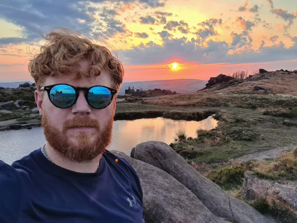 CLINUVEL Ambassador Matt Heywood stands in front of the UK's stunning peak district, wearing reflective sunglasses
